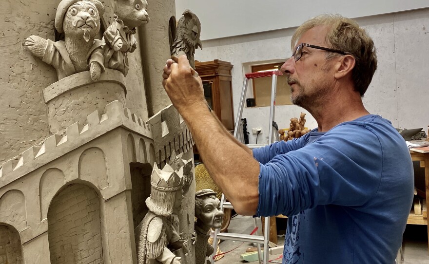 The rear portion of "A Beautiful Day for a Neighbor" features the famous castle and royal characters from <em>Mister Rogers</em>' <em>Neighborhood. </em>Sculptor Paul Day is seen here working on that portion of the piece.