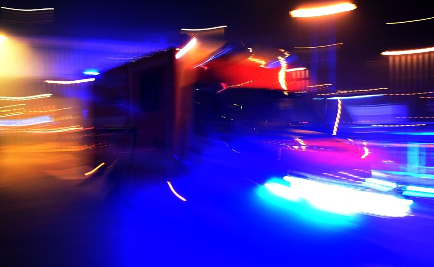 An ambulance car arrives as fireworks explode over the river Rhine during New Year's celebrations in Cologne on January 1, 2016.