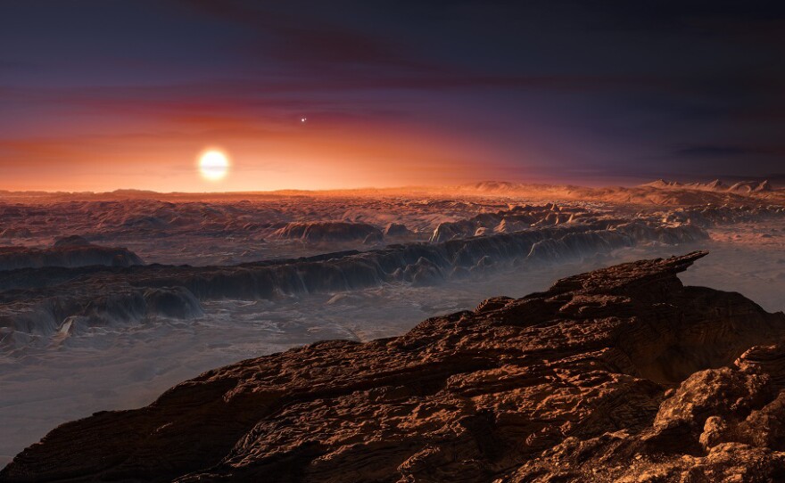 An artist's depiction of the surface of the planet Proxima b as it orbits the red dwarf star Proxima Centauri, the closest star to our solar system. The planet is a bit more massive than Earth, scientists say, and circles its star once every 11 days.