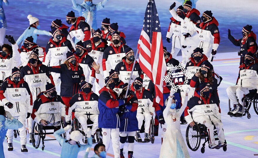 Flag bearers Tyler Carter and Danelle Umstead lead Team USA during the opening ceremony of the Beijing 2022 Winter Paralympics on Friday.