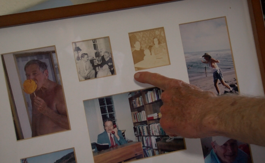 Robert Bettinger gestures toward a frame holding old photos of himself, June 22, 2016.