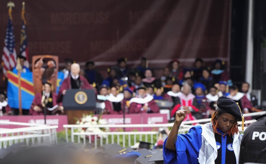 An attendee stands in protest with their back to President Biden as Biden speaks to graduating students at the Morehouse College commencement Sunday in Atlanta.