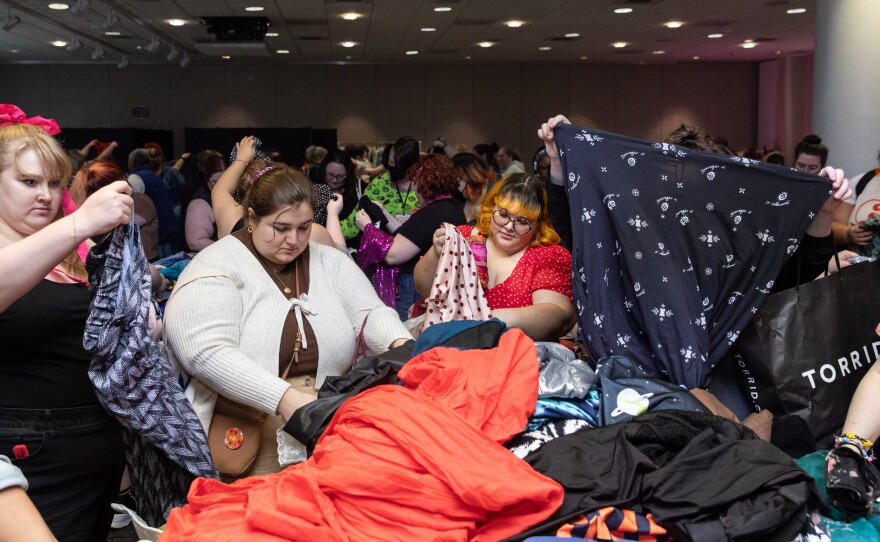 Attendees look through clothing at the third annual Plus Size Swap + Shop event during Philly FatCon last month. The tables were labeled by size, ranging from Xl-6X or size 14-32. Attendees had to bring 5-20 items of good condition clothing to participate.