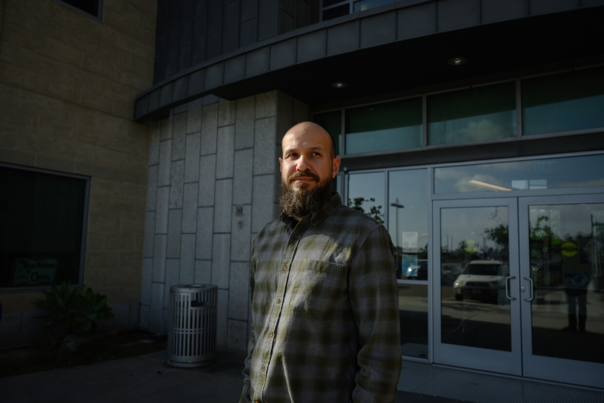 Alex Neu, an eResources and systems librarian, stands outside the National City Public Library in National City, California on October 13, 2025. Neu runs u-Tool-ize, the library's new tool lending program.