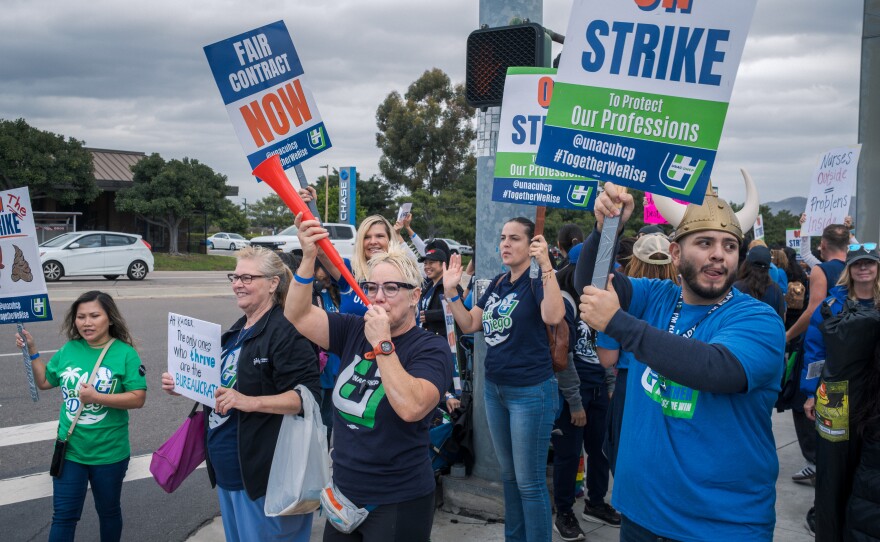Heath care workers strike outside Kaiser's San Diego Medical Center on October 14, 2025.