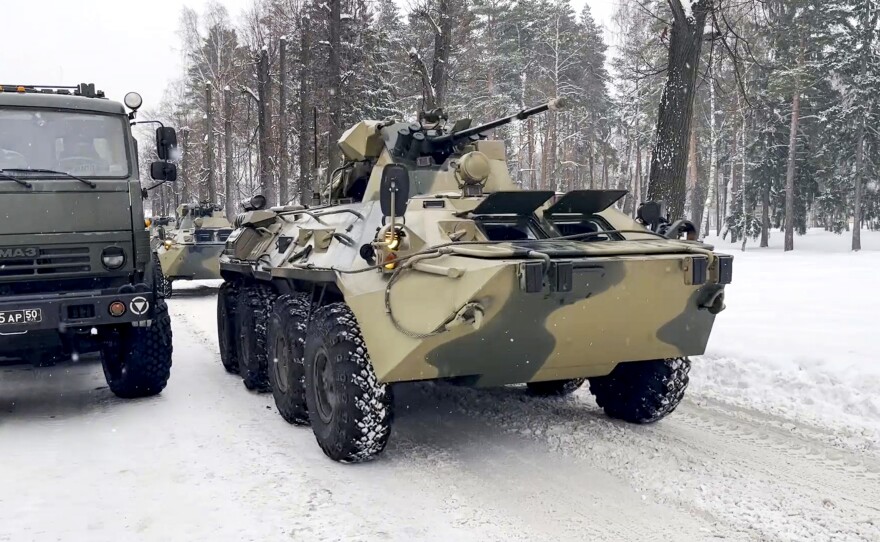 In this photo taken from video released by the Russian Defense Ministry Press Service, military vehicles of Russian peacekeepers are parked waiting to be uploaded on Russian military planes at an airfield outside Moscow to fly to Kazakhstan on Thursday.