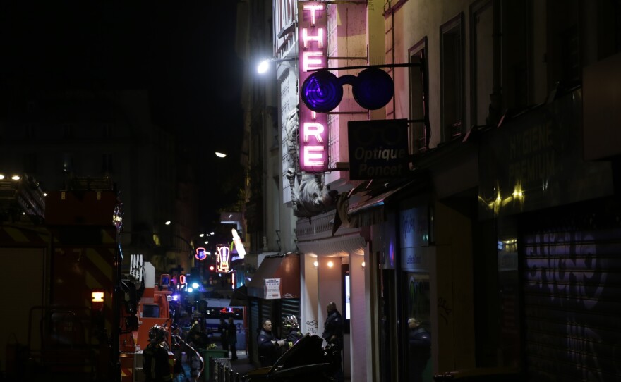 Police and rescuers survey the area around the Bataclan Theater after a coordinated attack in Paris on November 13.