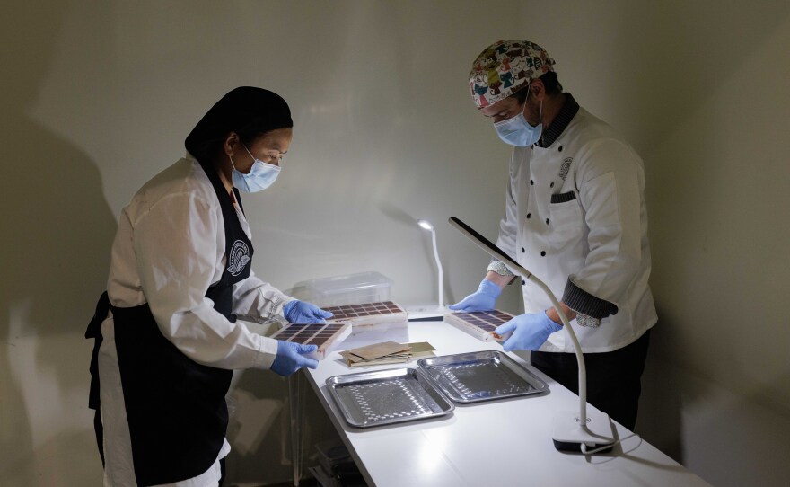 Each chocolate, identically processed, is wrapped in gold foil. It's the final step of preparation before the samples are distributed for tasting and evaluation.