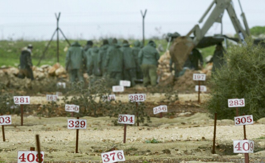 Israeli soldiers exhume the bodies of Lebanese fighters from one of Israel's "cemeteries of numbers." Israel has built several cemeteries for enemy dead. Israel often holds the bodies for years, eventually exchanging them for Israeli dead. In this 2004 photo from northern Israel, the Lebanese group Hezbollah and Israel are shown exchanging both living captives and the remains of the dead.