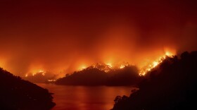 Flames from the LNU Lightning Complex fires burn around Lake Berryessa in unincorporated Napa County, Calif., on Wednesday, Aug. 19, 2020. 