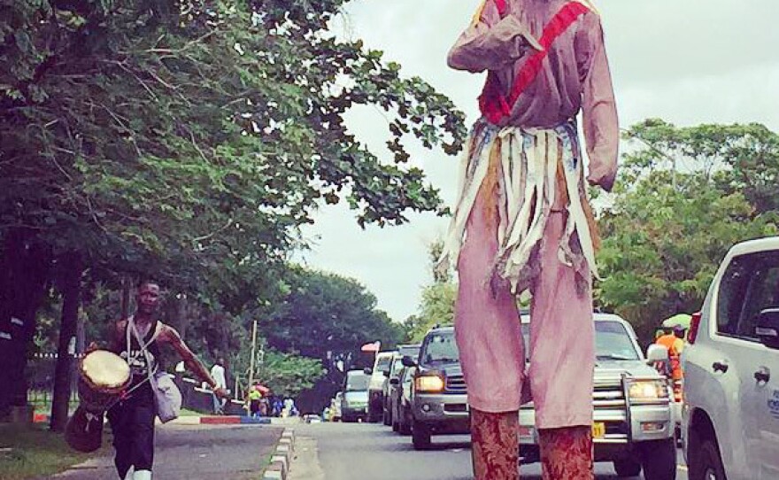 A country devil from the Gio tribal group walks through a neighborhood in Monrovia, Liberia's capital, as part of the pre-independence day celebration.