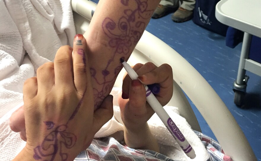 The Bagram nurses have Ameera draw henna patterns to distract her from the pain.
