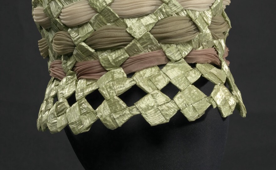 Mae Reeves designed this green raffia lamp shade hat with silk and polyester.