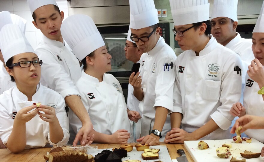 Students sample the results of their labors in Yvonne Ruperti's pastry class at the Culinary Institute of America's Singapore branch.