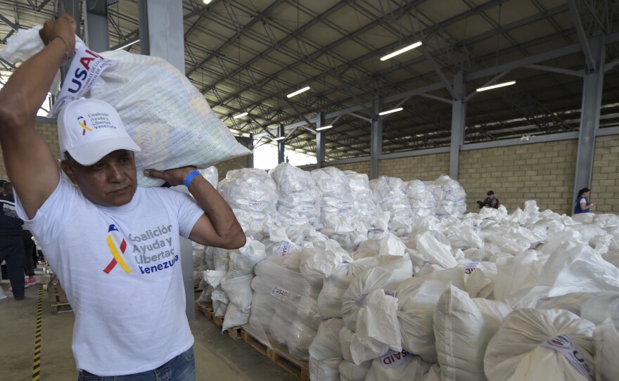 A volunteer carries a bag with U.S. humanitarian aid goods in Cúcuta, Colombia, along the border with Venezuela, on Feb. 8.