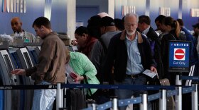 Passengers wait in line at the United ticket counter at O'Hare International Airport in Chicago.