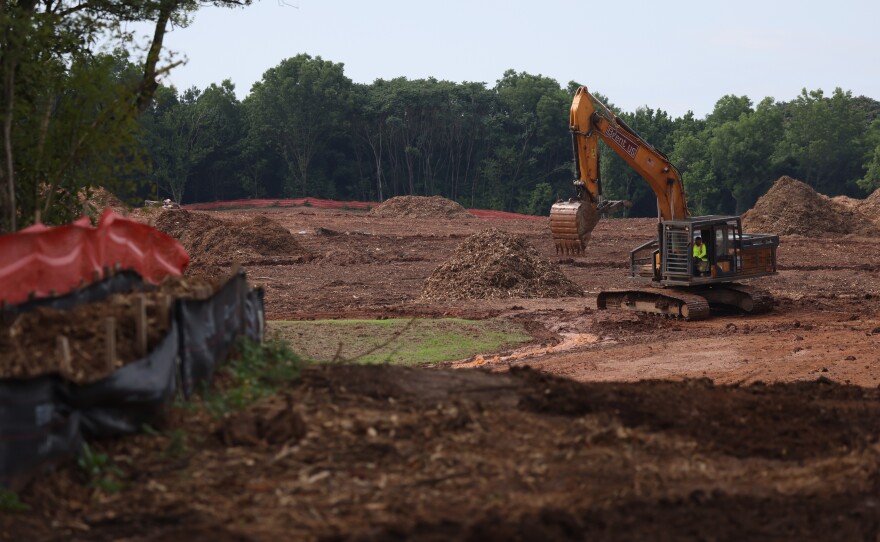 Construction equipment at work with protection from law enforcement at the site of Atlanta Public Safety Training Center that protesters refer to as "Cop City" in Atlanta, Georgia, U.S., June 23, 2023.