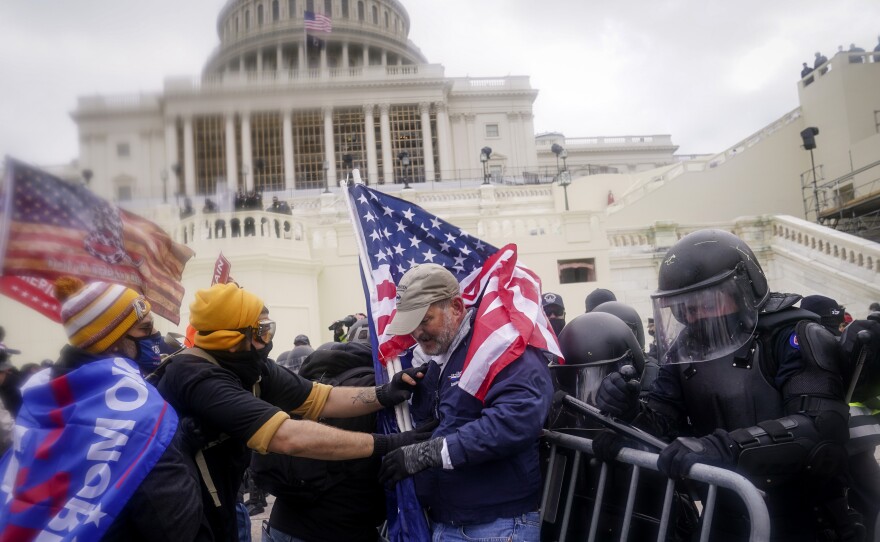 Rioters try to break through a police barrier at the U.S. Capitol on Jan. 6, 2021.