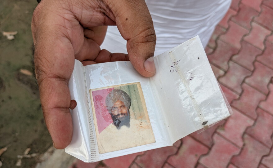 Ranjit Singh Babbar shows a photograph of his father Atma Singh who he says was abducted and killed by the Punjab police during in 1990.