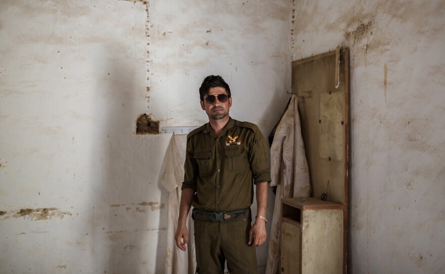 Saeed Murad, the brother of Yazidi activist and Nobel Peace laureate Nadia Murad, visits his former family home in Kocho, northern Iraq. A white cloak that his mother used to wear hangs in the corner behind him. Murad is one of the few survivors from Kocho. Shot six times by a young ISIS fighter, he was left for dead among the bodies.