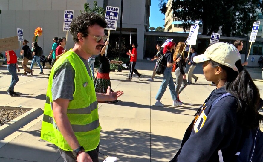 Graduate student teaching assistant Zack Goldberg talking to an undergraduate at UC San Diego about the graduate workers' strike, Nov. 15, 2022.