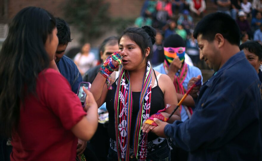In this Dec. 25, 2015, photo, Karen Quispe prepares to fight another woman for sport at the <em>Takanakuy</em> ritual fighting event on the outskirts of Lima, Peru. Taking part in the fights is voluntary, and no one is obligated to accept a challenge. But by refusing to participate, the challenged party automatically acknowledges the superiority of their rival.