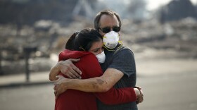 Howard Lasker, right, comforts his daughter, Gabrielle, who is visiting their home for the first time since a wildfire swept through it Sunday, Oct. 15, 2017, in Santa Rosa, Calif. 