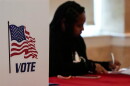 A Fulton County, Ga. staff member works as people vote in a runoff election in Atlanta on June 16, 2026.