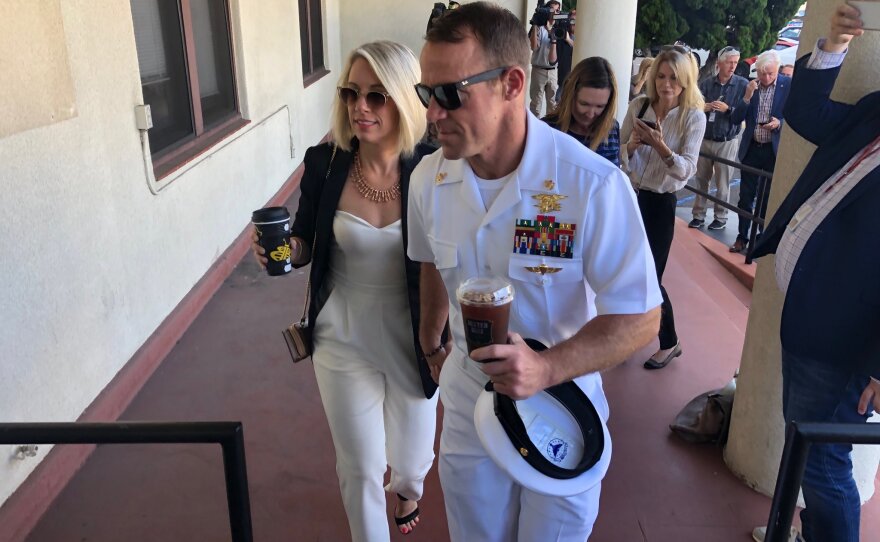 Navy Special Operations Chief Edward Gallagher, right, walks with his wife, Andrea Gallagher as they arrive to military court on Naval Base San Diego, Tuesday, July 2, 2019.