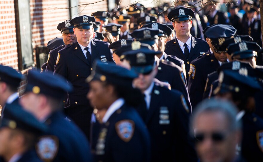 New York City police officers attend the wake of their fellow NYPD officer.