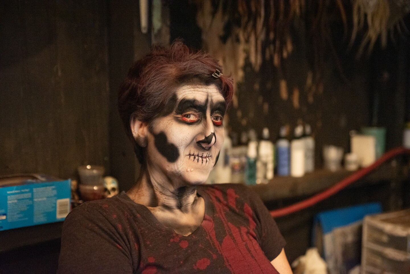 KPBS arts reporter Beth Accomando looking very happy in the makeup chair at The Haunted Trail in Balboa Park on Sept. 25, 2025.