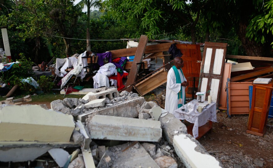 Rev. Jean Eddy Desravines celebrating Mass in the ruins of his church.