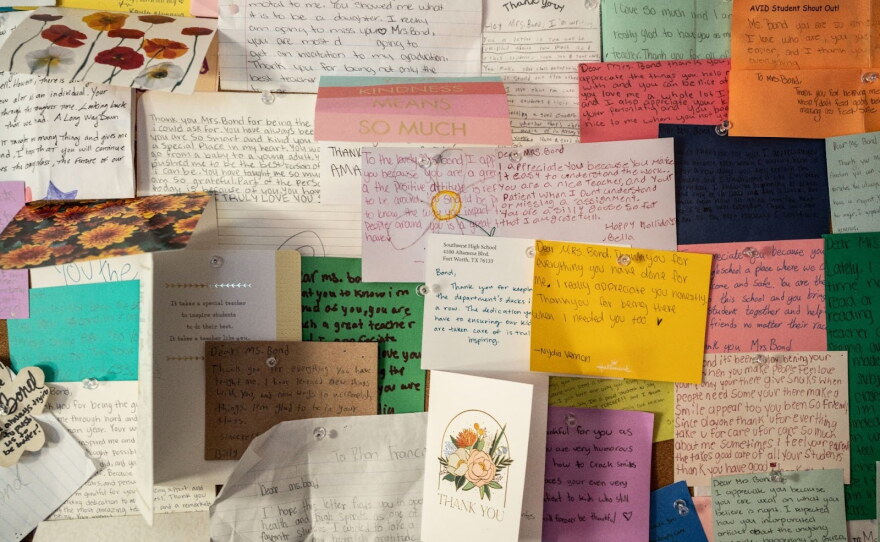 Bond's classroom includes a display of handwritten thank you notes from students.