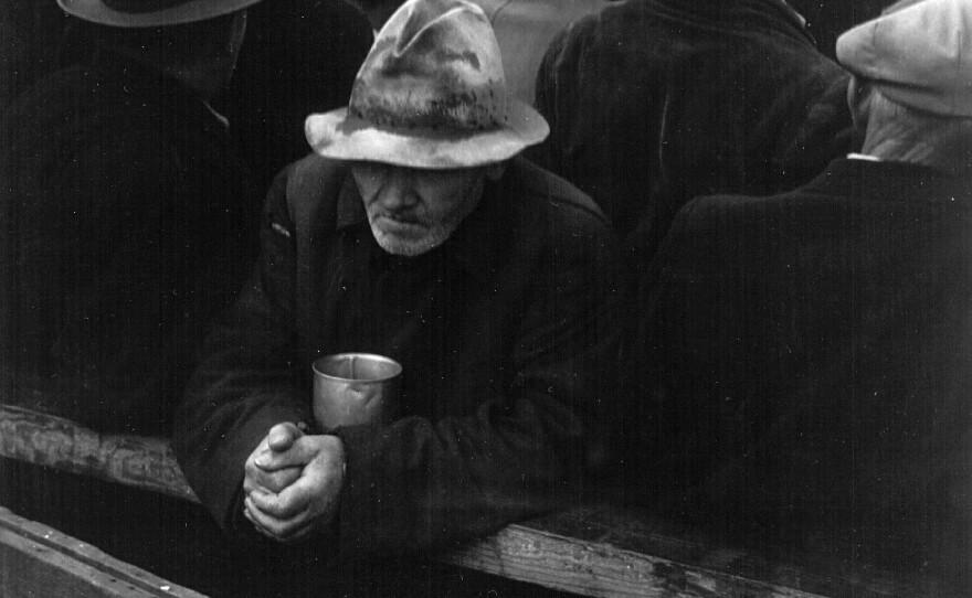 A man waits in a bread line in San Francisco during the winter of 1933.