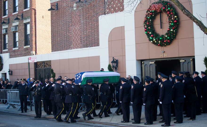 Ramos' casket is carried into the church.