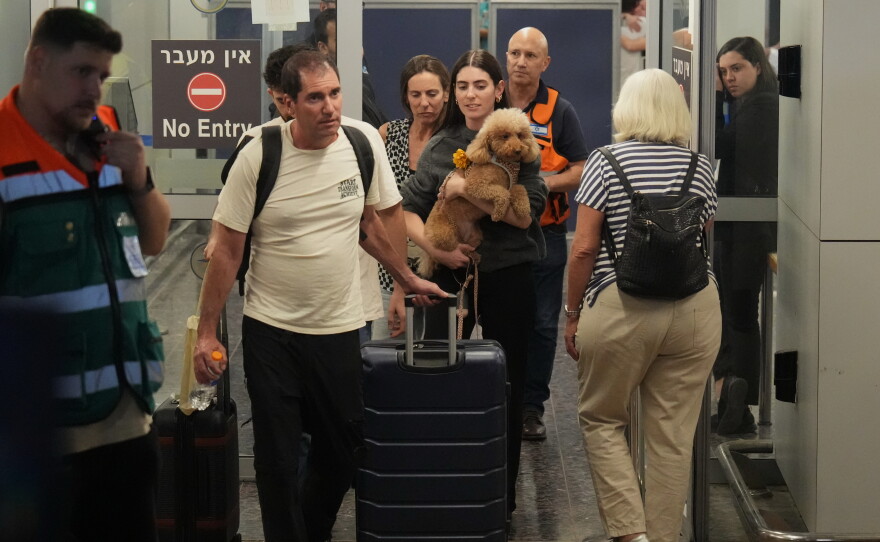 Passengers who experienced an emergency landing in Saudi Arabia during a flydubai flight arrive at Ben Gurion International Airport, near Tel Aviv, Israel, Wednesday.