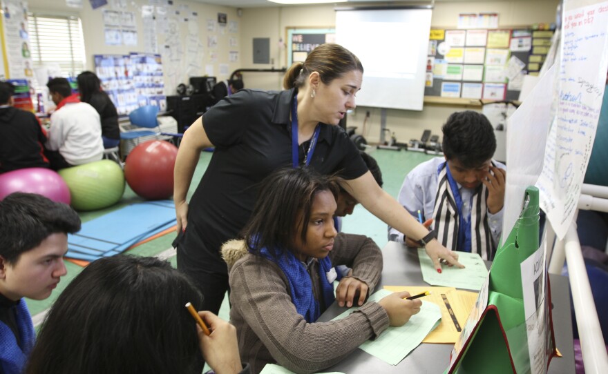Christine Gilliard, a phys ed teacher, used to teach at a large high school where she had "a two-story gym and two storage closets." Now she teaches out of a trailer-sized temporary building. "We may not have the best of everything, but we have each other," she says.