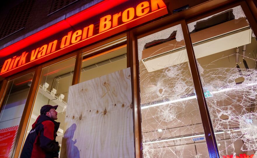 Protesters threw fireworks and rocks at police, damaged storefronts, and looted stores during demonstrations on Monday in the Netherlands.