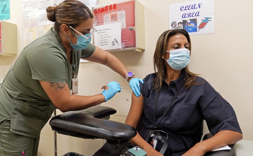 A fourth Pfizer COVID-19 vaccine shot is administered at the Dr. Kenneth Williams Health Center in Los Angeles on Nov. 1.