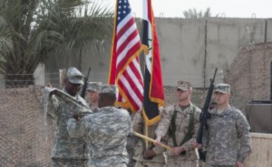 The mission flag is cased at the end of mission ceremony in Baghdad, Iraq December 15, 2011