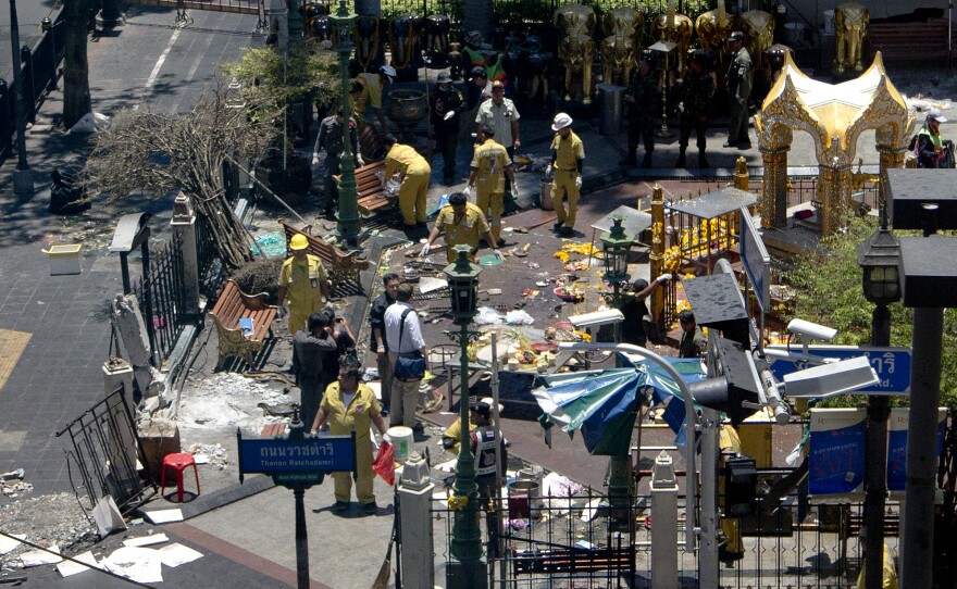 Investigations continue at the Erawan Shrine the morning after an explosion in Bangkok, Thailand. Thailand's prime minister on Tuesday promised that authorities would quickly track down those responsible for the bombing.