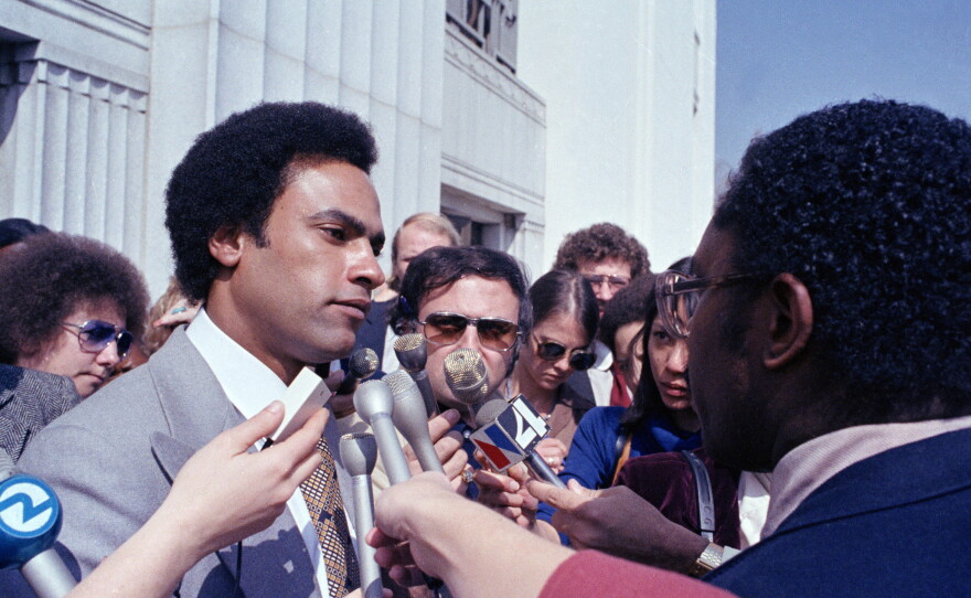 In this March 7, 1979 file photo, former Black Panther leader Huey Newton speaks to reporters outside the courthouse in Oakland, Calif.