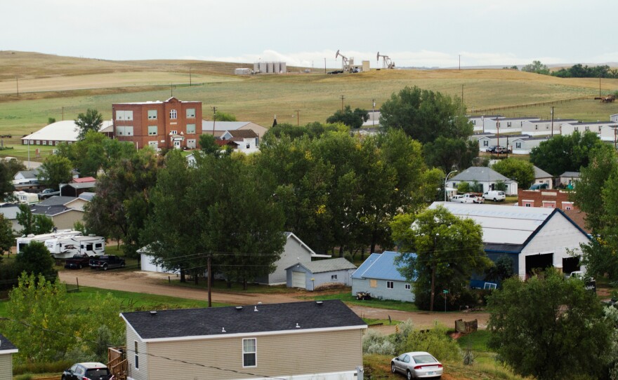 Oil wells sit atop a hill just outside of Alexander, N.D., a small town of about 300 in the heart of the Bakken oil patch.