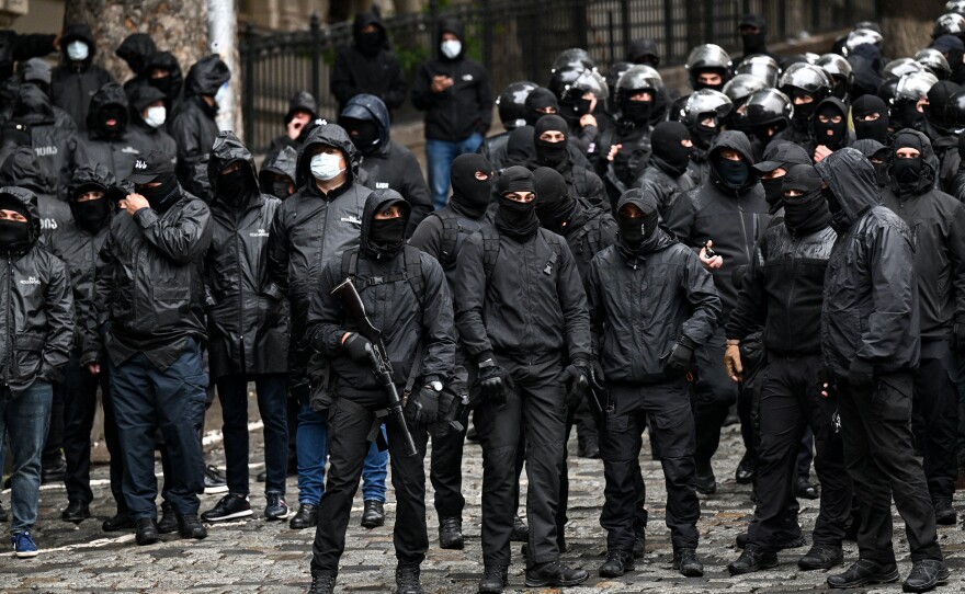 Georgian law enforcement officers are seen deployed on streets as protesters rally against the controversial "foreign influence" bill in Tbilisi on Tuesday.