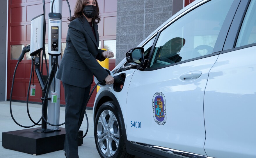 Vice President Kamala Harris charges an electric vehicle in Brandywine, Md., on Dec. 13, 2021. The Biden administration has a plan to build a network of chargers across the country.