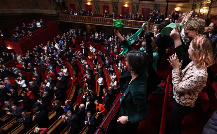 French lawmakers applaud after National Assembly President Yael Braun-Pivet announced the result of the vote during a joint session of parliament in the Palace of Versailles, southwestern of Paris, on Monday, to anchor the right to abortion in the country's constitution.