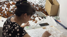 A worker in a mahjong workshop in Taixing, China, inspects each tile to ensure there are no imperfections before they're shipped off to the U.S. and sold for hundreds of dollars a set.