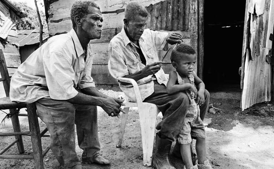 In the Dominican Republic, 92-year-old Julien cuts the hair of a 3-year-old. The boy was born in the DR but denied a birth certificate because his parents are of Haitian descent, says Constantine.