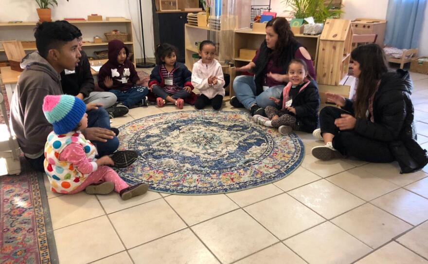 Children and volunteers sing together at "The Nest" in Tijuana on January 27, 2020.
