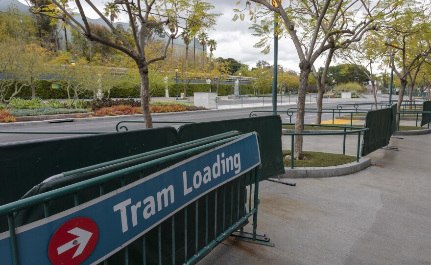 A parking tram loading area stands vacant on the first day of the closure of Disneyland and Disney California Adventure theme parks as fear of the spread of coronavirus continue, in Anaheim, California, on March 14, 2020.